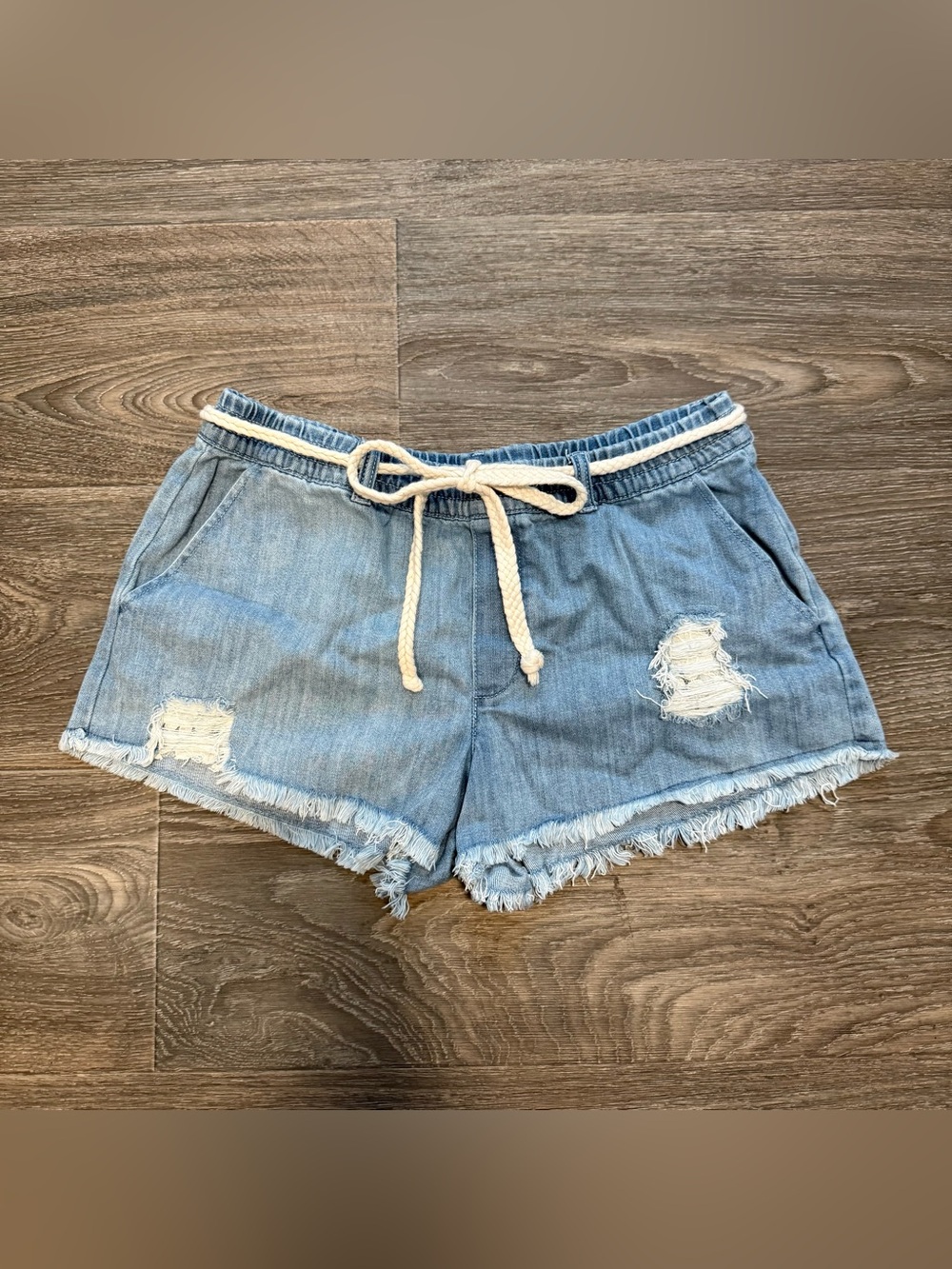 aerie light wash distressed raw hem denim flowy shorts